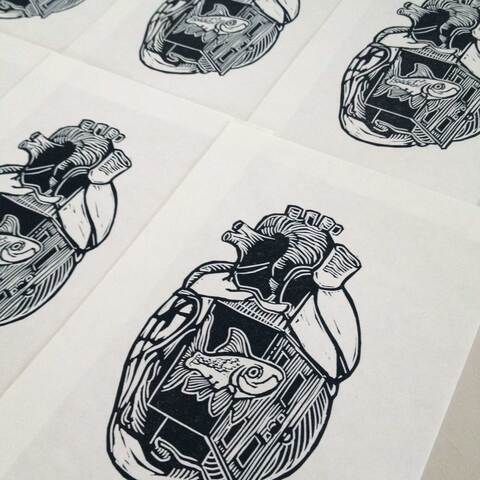 Hand printed linoleum prints laid out to dry.